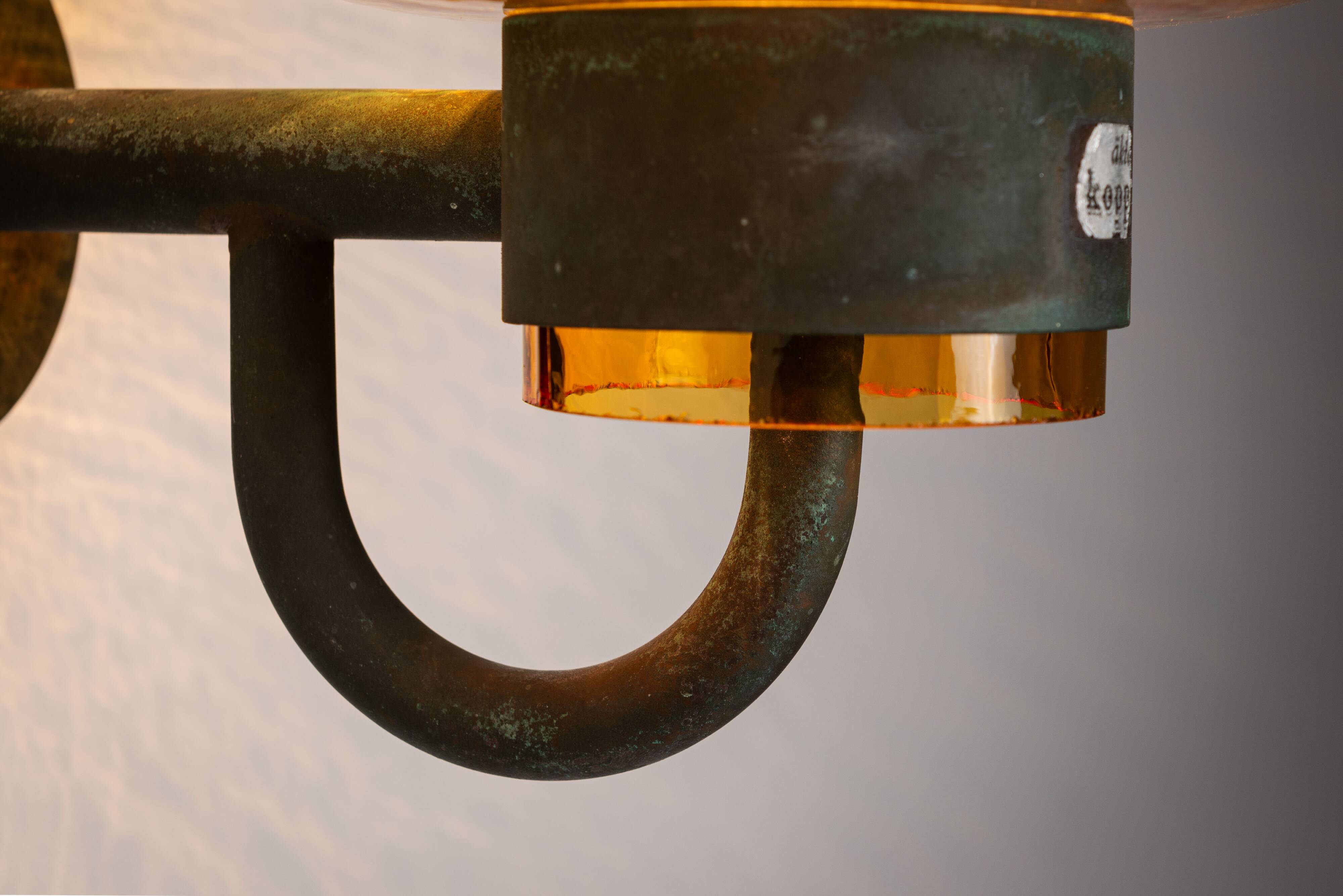 Pair of brass wall lamps with decorated amber coloured shades