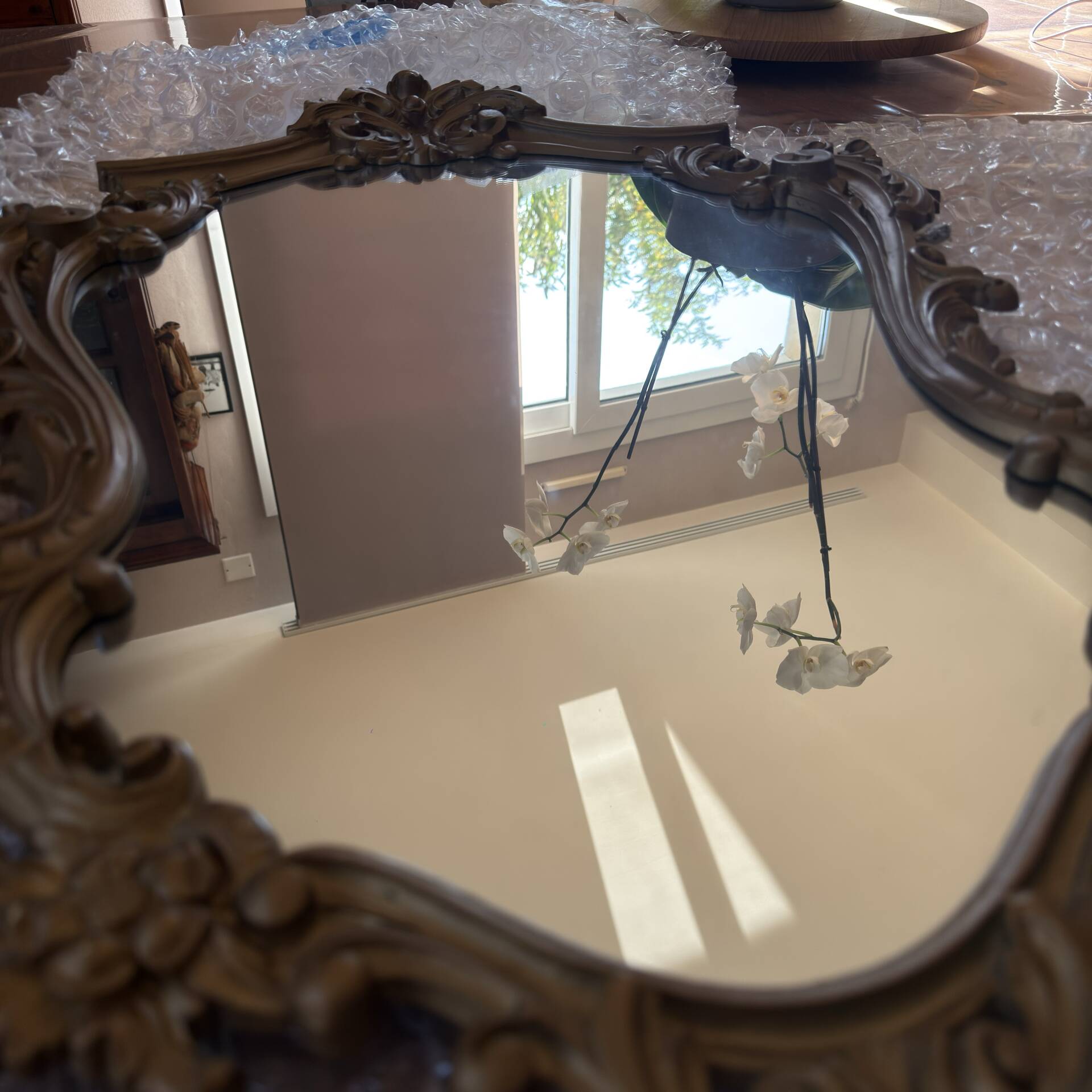 Antique mirror in Louis XV Rocaille style with carved frame.