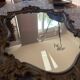 Antique mirror in Louis XV Rocaille style with carved frame.