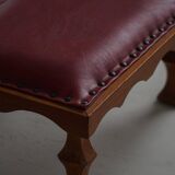 Danish sculpted oak stool from the mid-20th century with a red leather seat, 1950s.