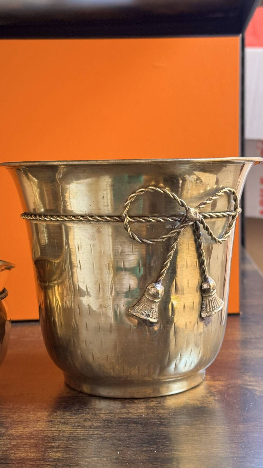 Pair of brass plant pots, decorated with cord and tassels.
