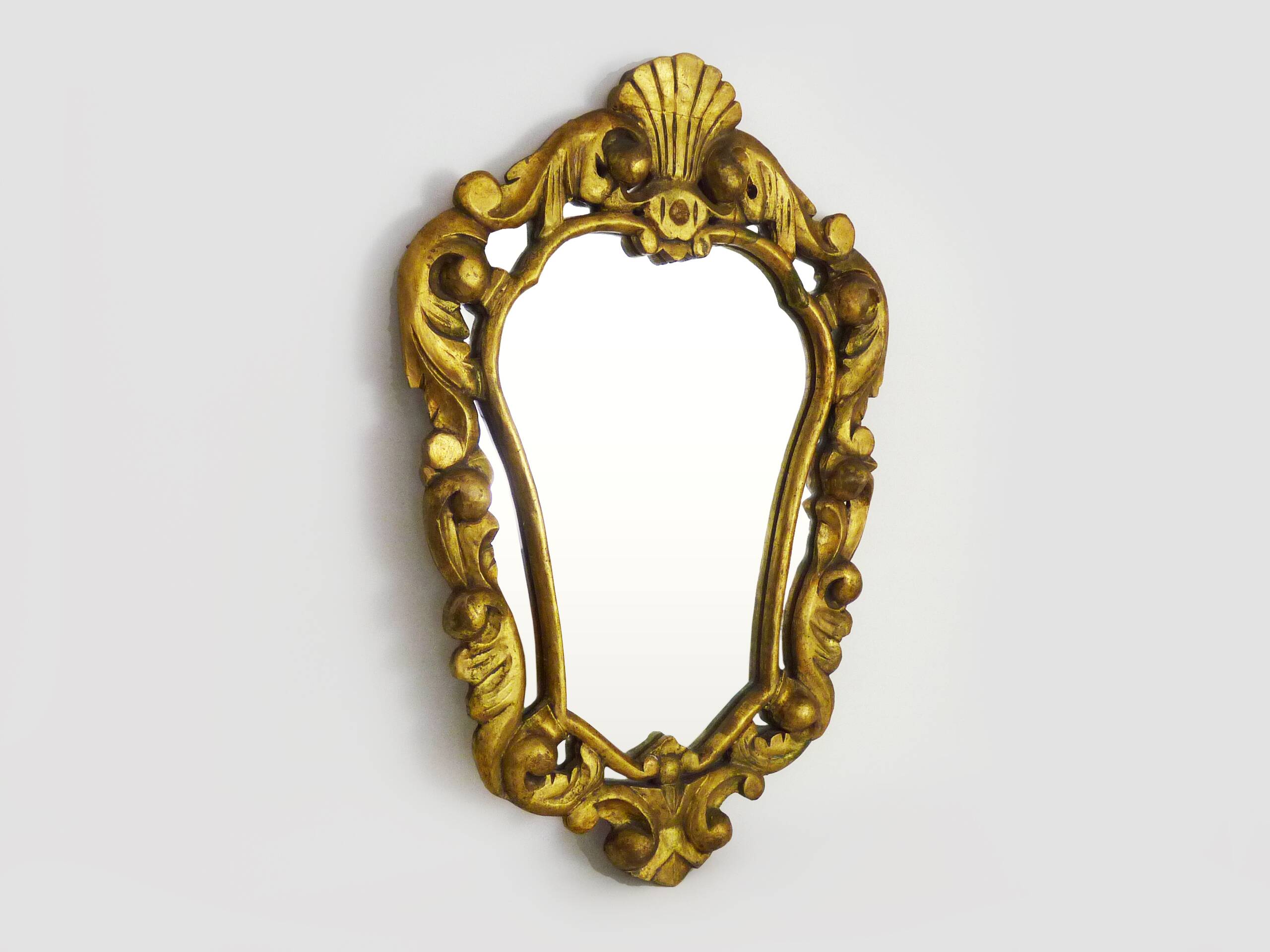 Old wall mirror in wood and gilded stucco with shell decoration, Louis XV style pediment mirror