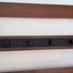 Vintage teak wall coat rack with 5 hooks and mirror.