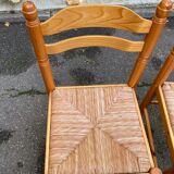2 straw-seated chairs in light-colored solid wood
