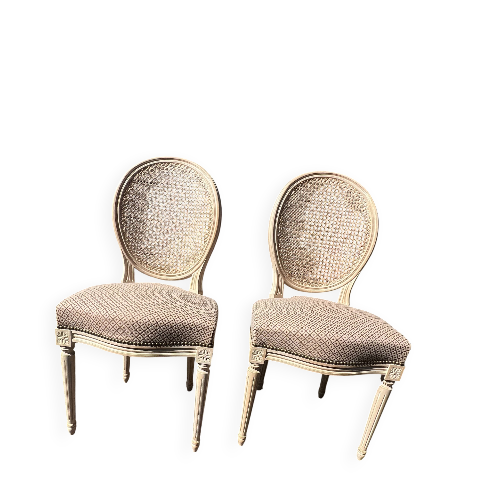 Pair of cerused chairs with fabric seats and caned backs.