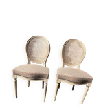 Pair of cerused chairs with fabric seats and caned backs.