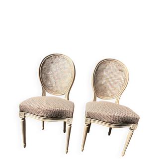 Pair of cerused chairs with fabric seats and caned backs.