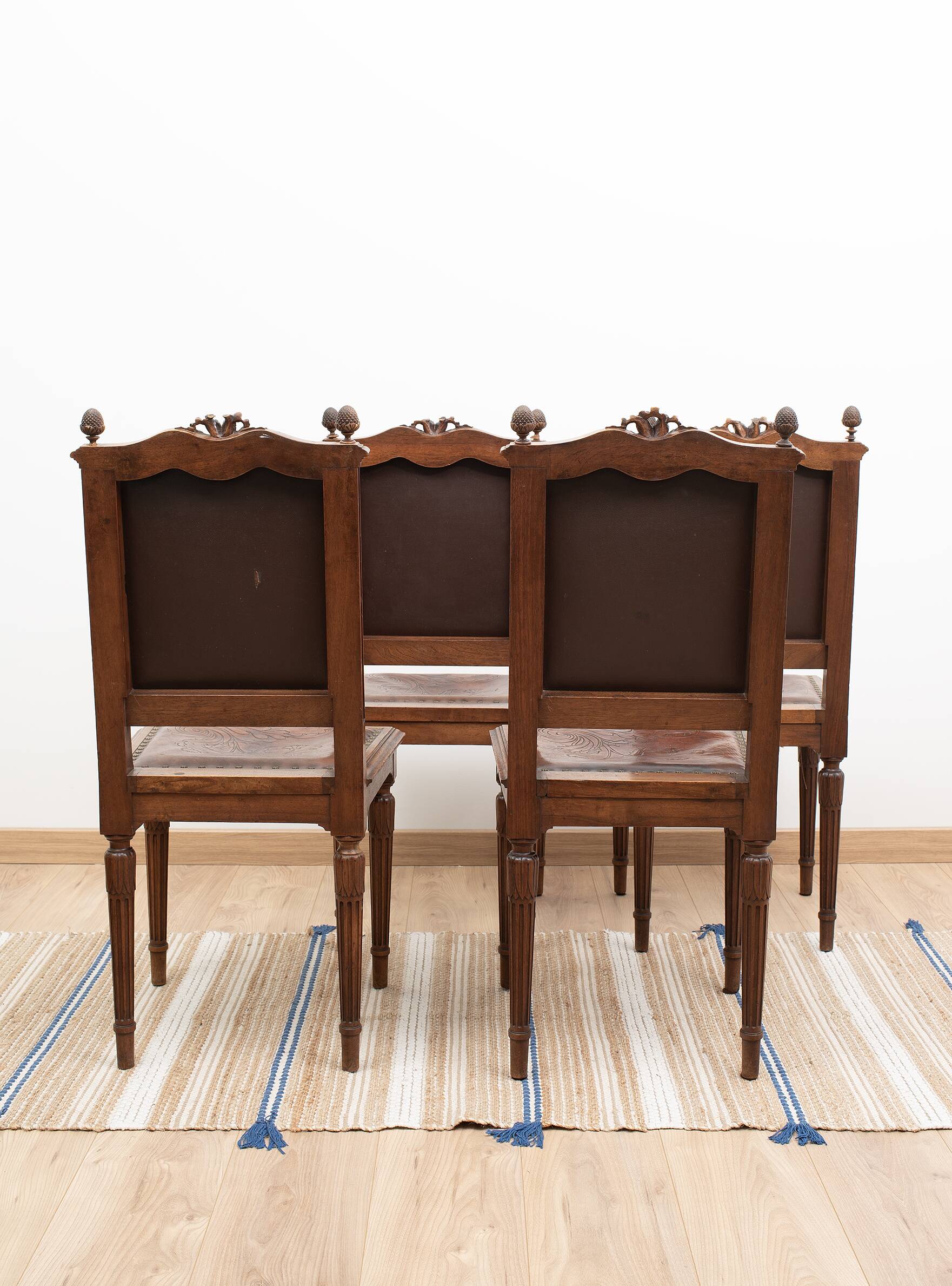 Set of 4 Louis XVI style chairs in carved wood and embossed leather.