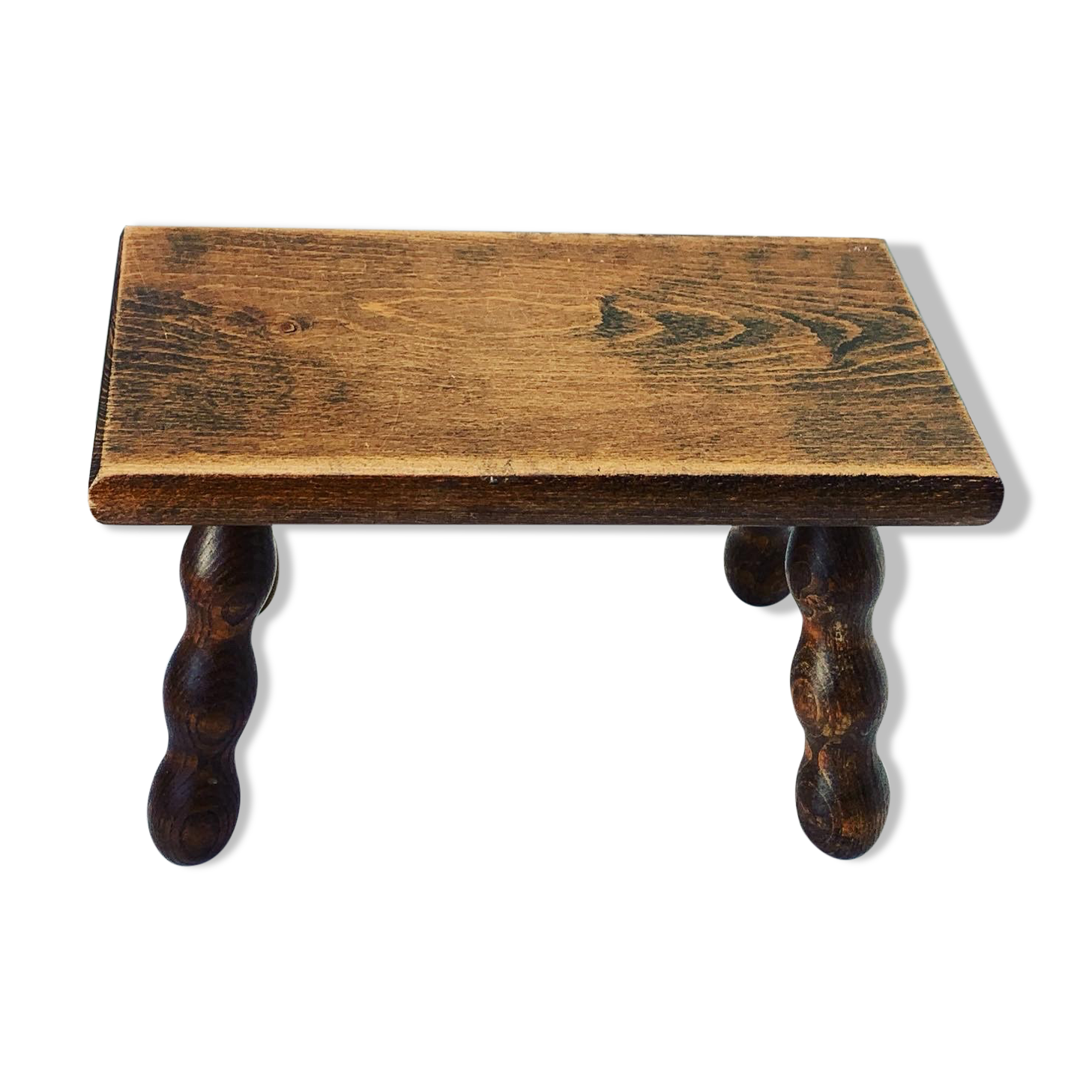 Footstool in varnished wood turns old
