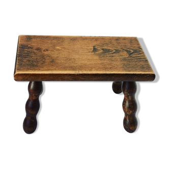Footstool in varnished wood turns old