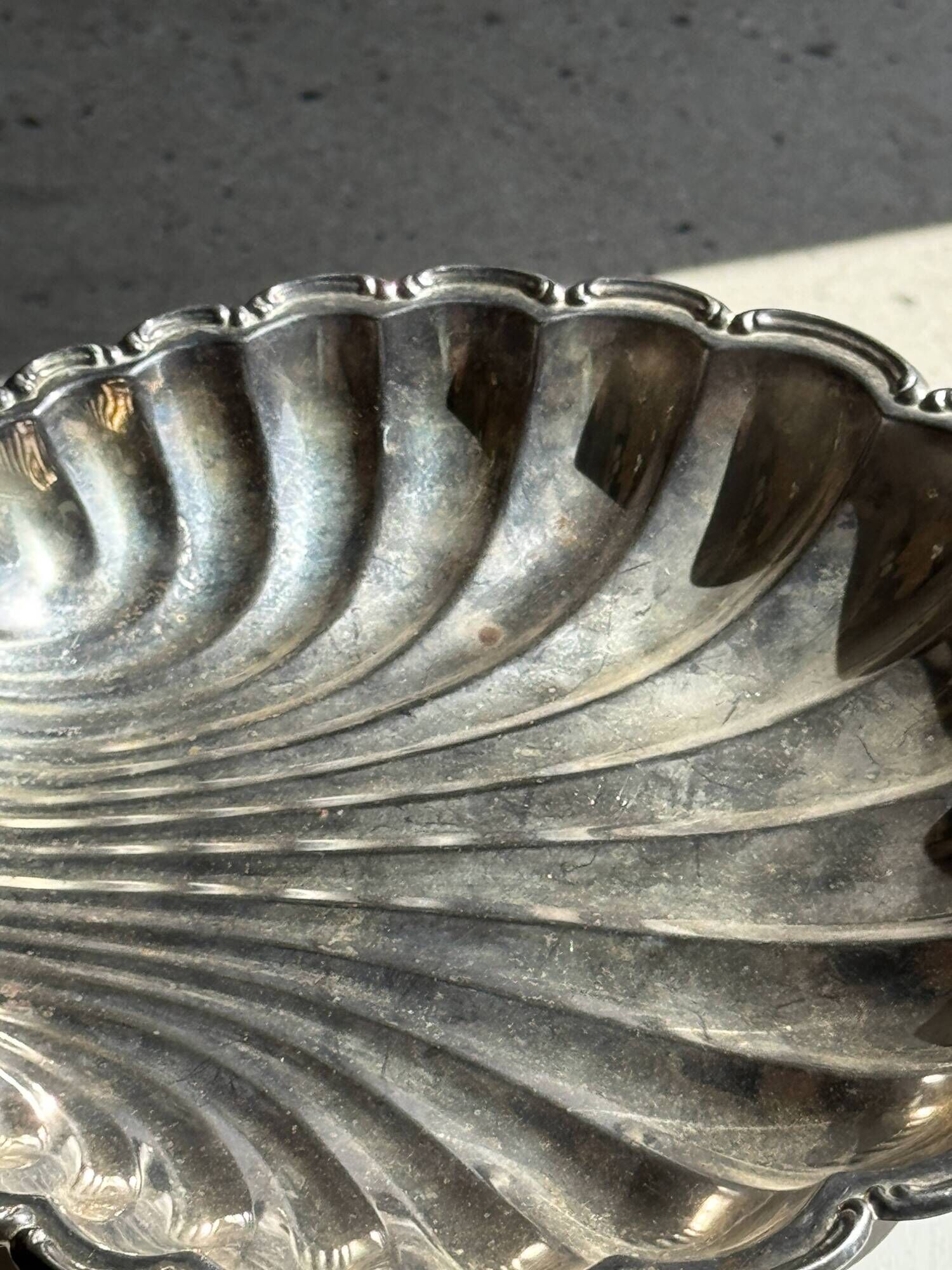 Large antique silver-plated bowl in the shape of a shell.