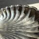 Large antique silver-plated bowl in the shape of a shell.