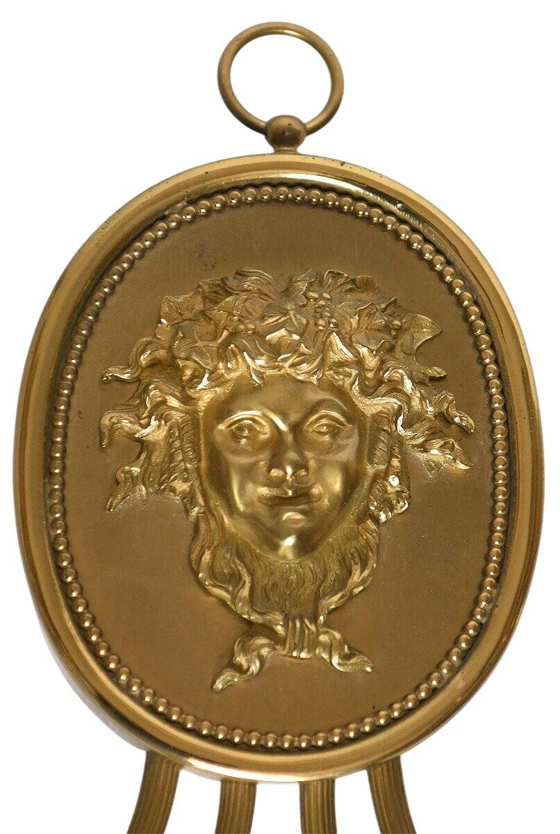 Pair of wall sconces with a relief decoration of a Bacchus mask.