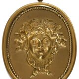 Pair of wall sconces with a relief decoration of a Bacchus mask.