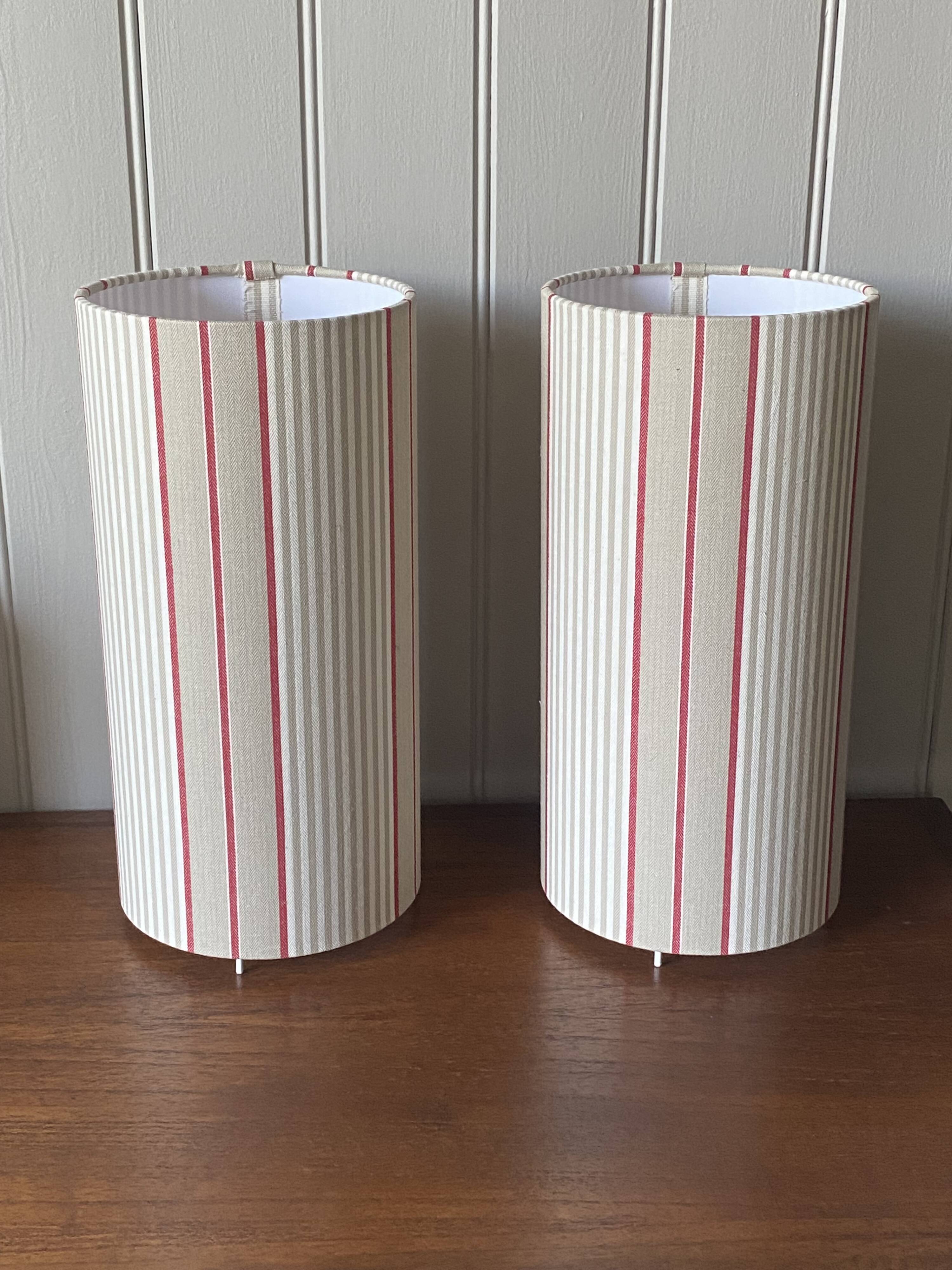 Pair of striped fabric bedside lamps.