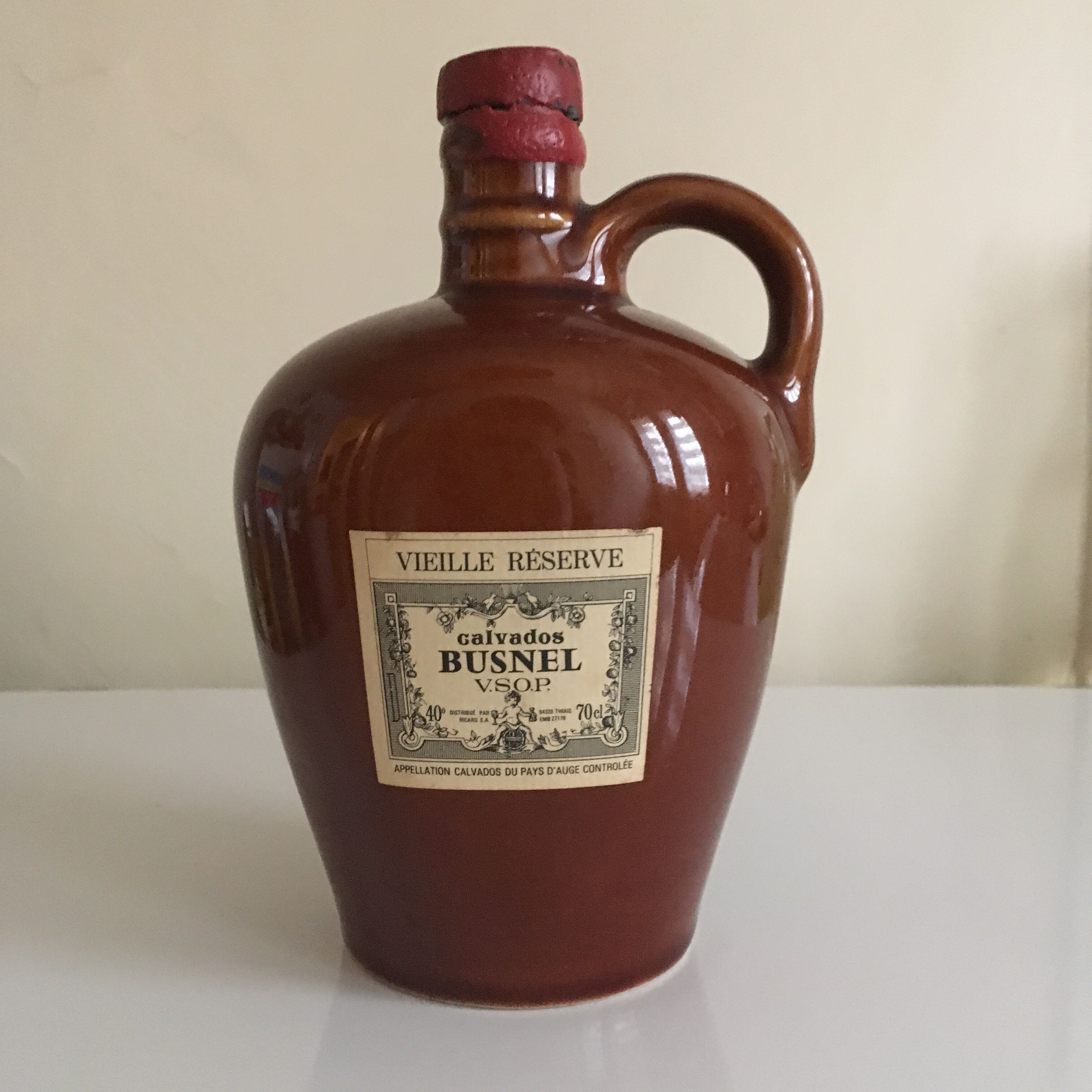 Old bottle of Calvados in sandstone