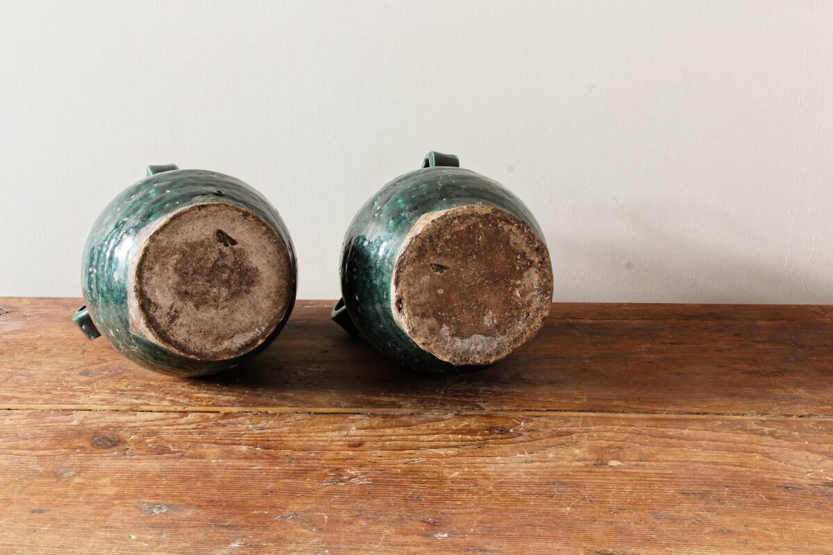Set of two Chinese green glazed stoneware storage jars.