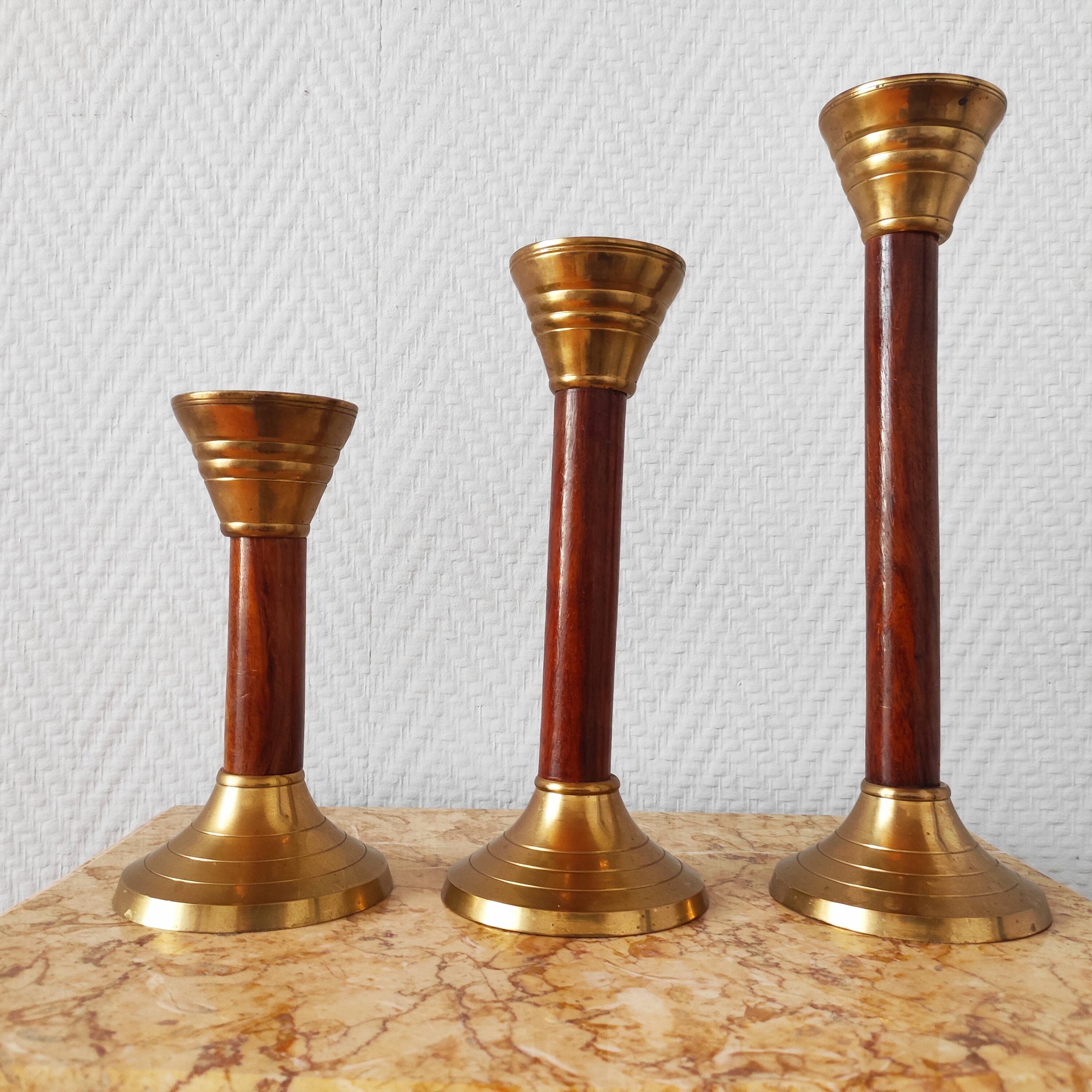 Set of three vintage wooden and brass candlesticks