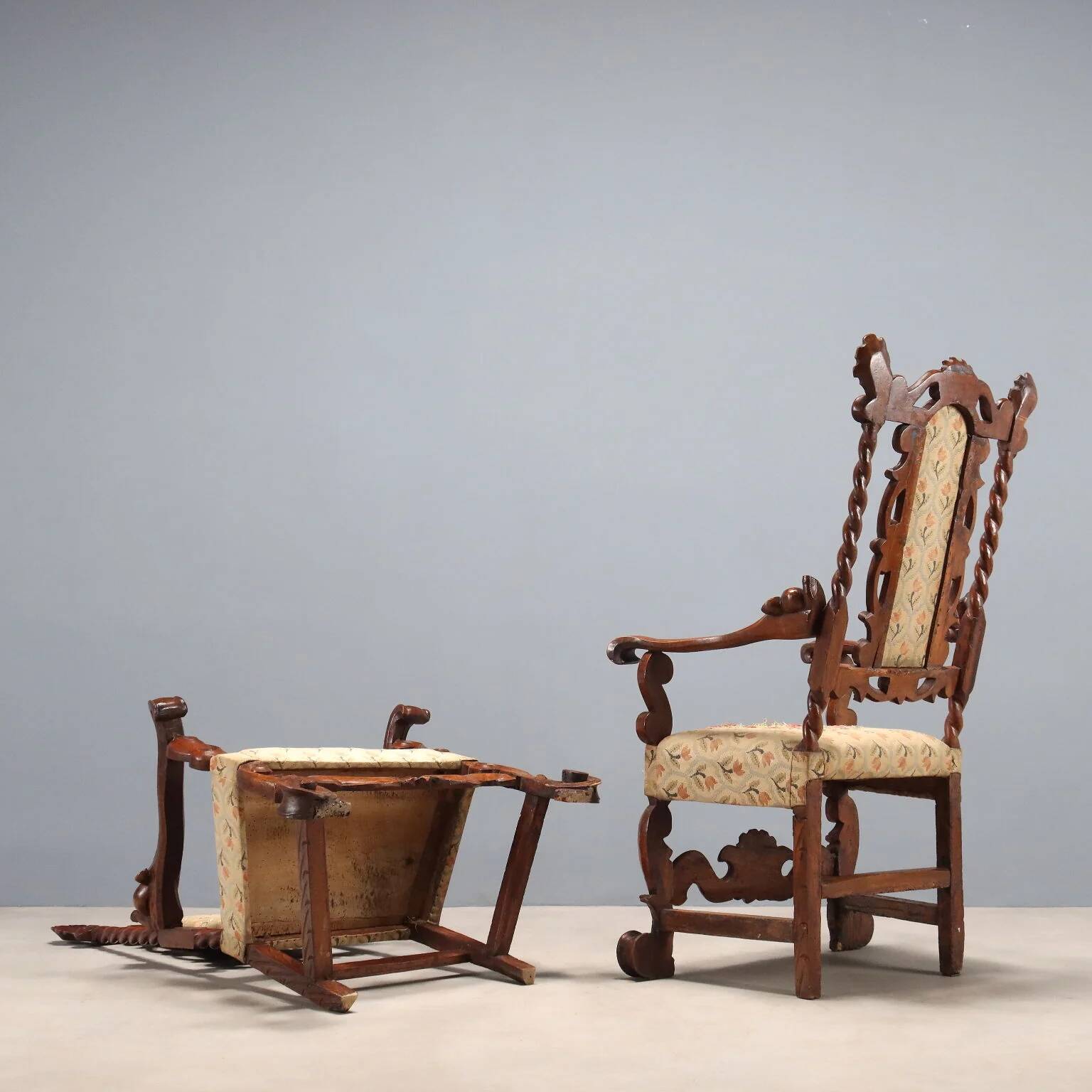 Pair of antique Baroque armchairs in walnut and fabric, Italy, 17th century.