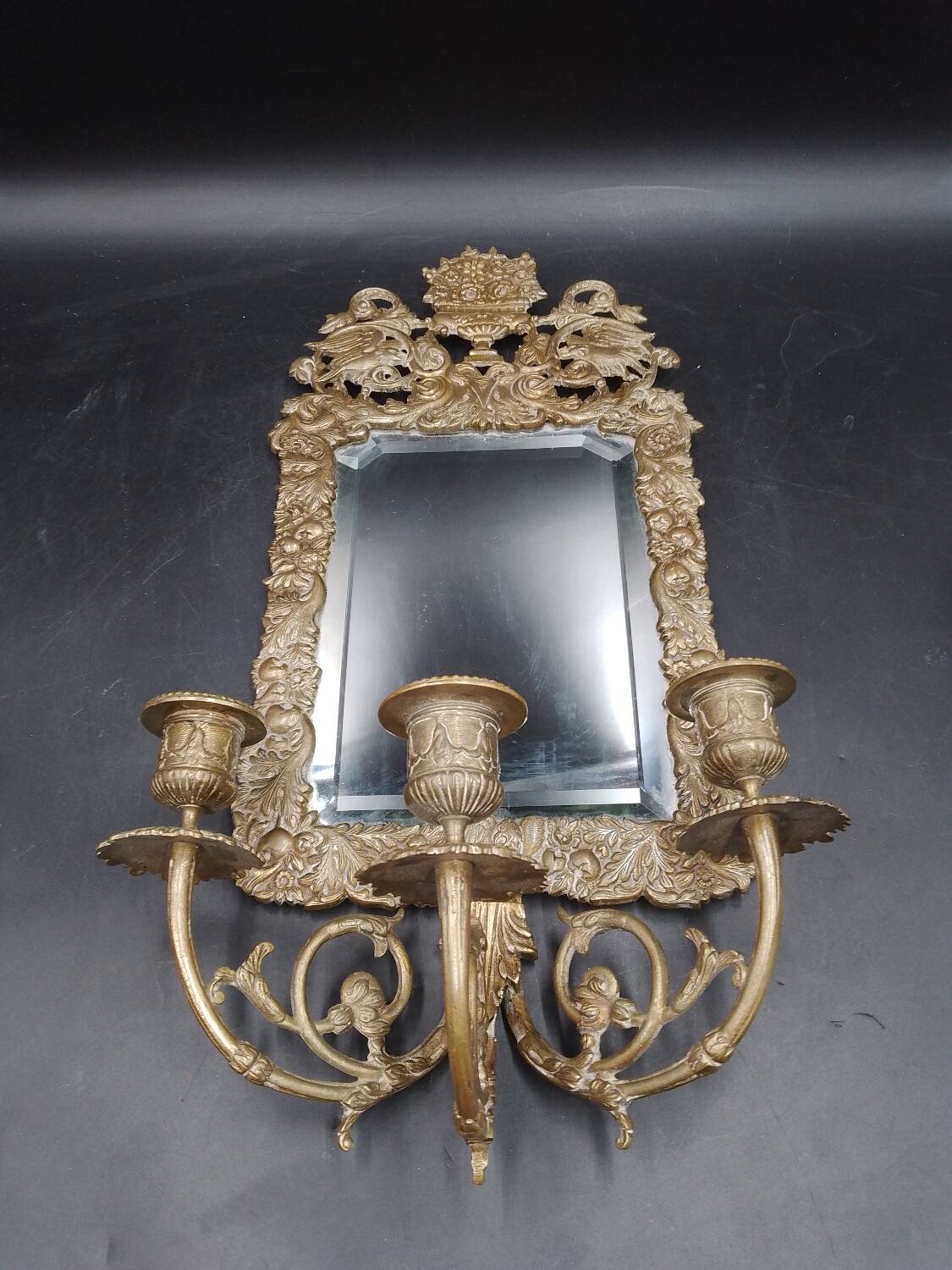 Repousse brass wall mirror with three candles, beveled glass, end of 19th century, double eagles