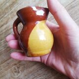 Small two-tone brown-yellow terracotta pitcher