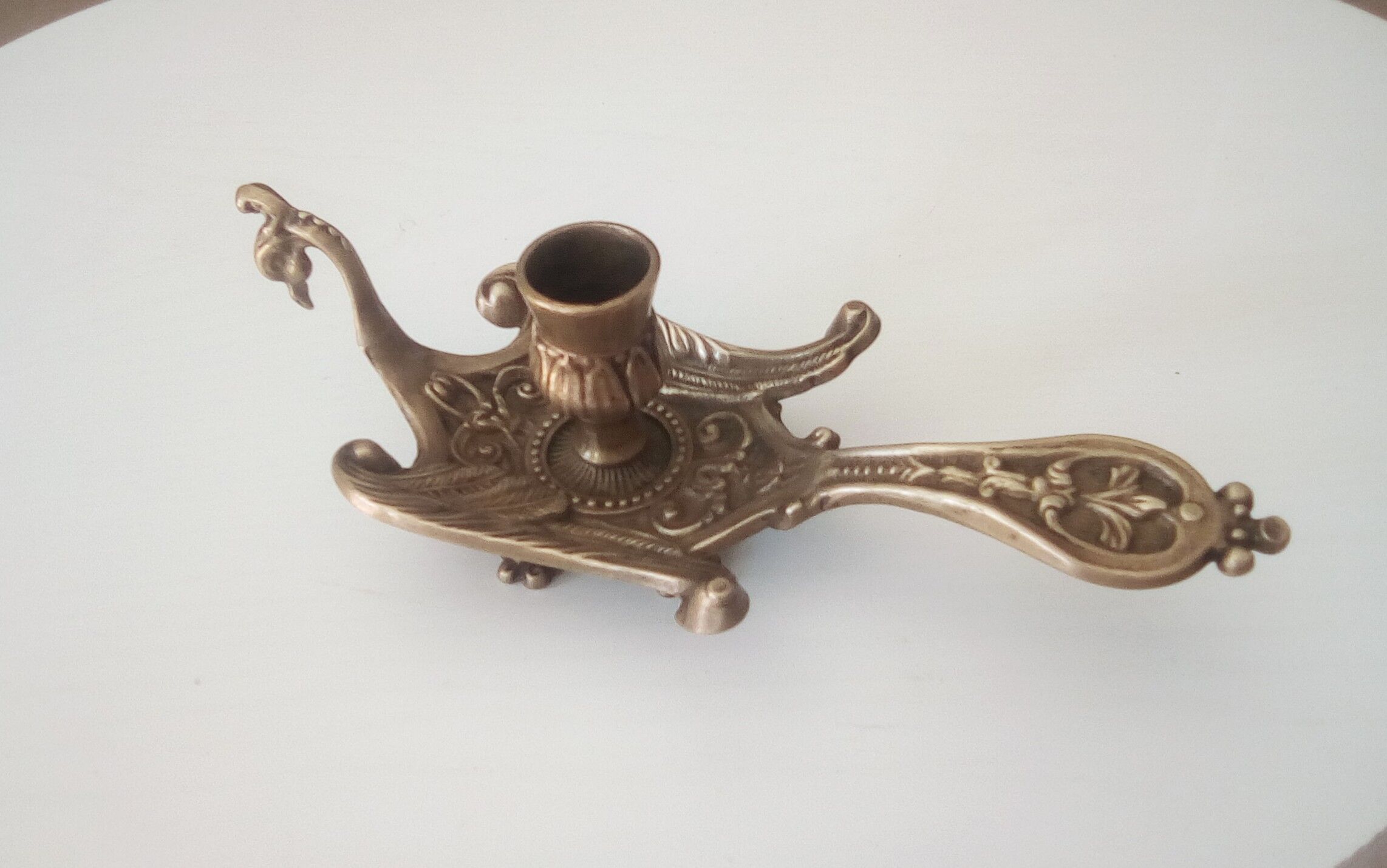 Old hand candlestick in chissed solid brass