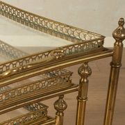 Set of 3 vintage Hollywood Regency nesting tables with brass frame and glass tops (1960s)