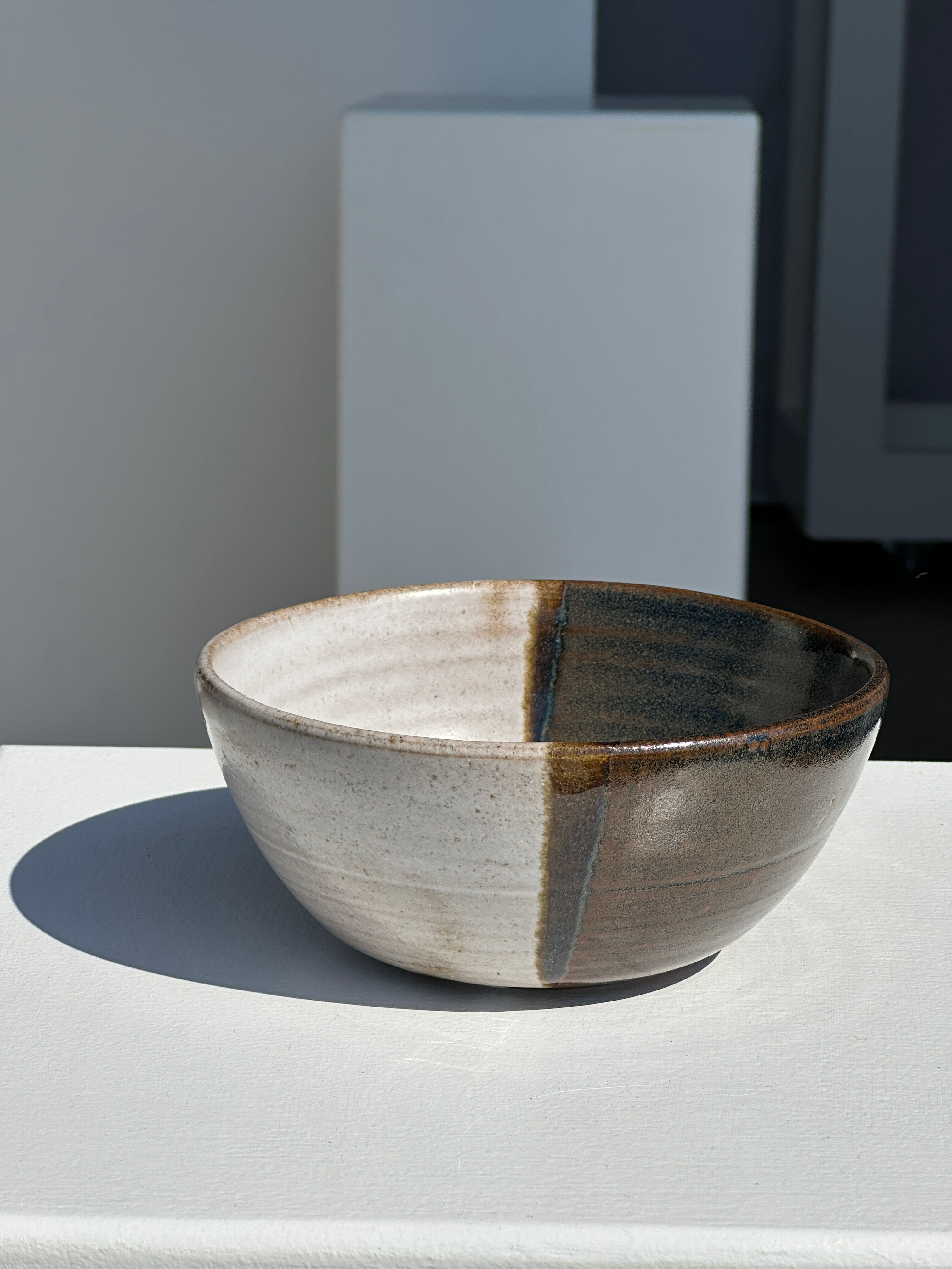 White and glossy brown two-tone ceramic bowl, matt earth