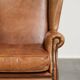 Sheepskin wingback armchair in a light cognac colour in English style