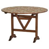 19th-century French round wine table with an adjustable top and floral textile surface.