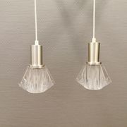 A set of smaller hanging lamps, in hard pressed glass, with metal top