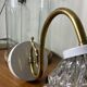Large pair of brass swan neck wall lights with transparent glass globes.