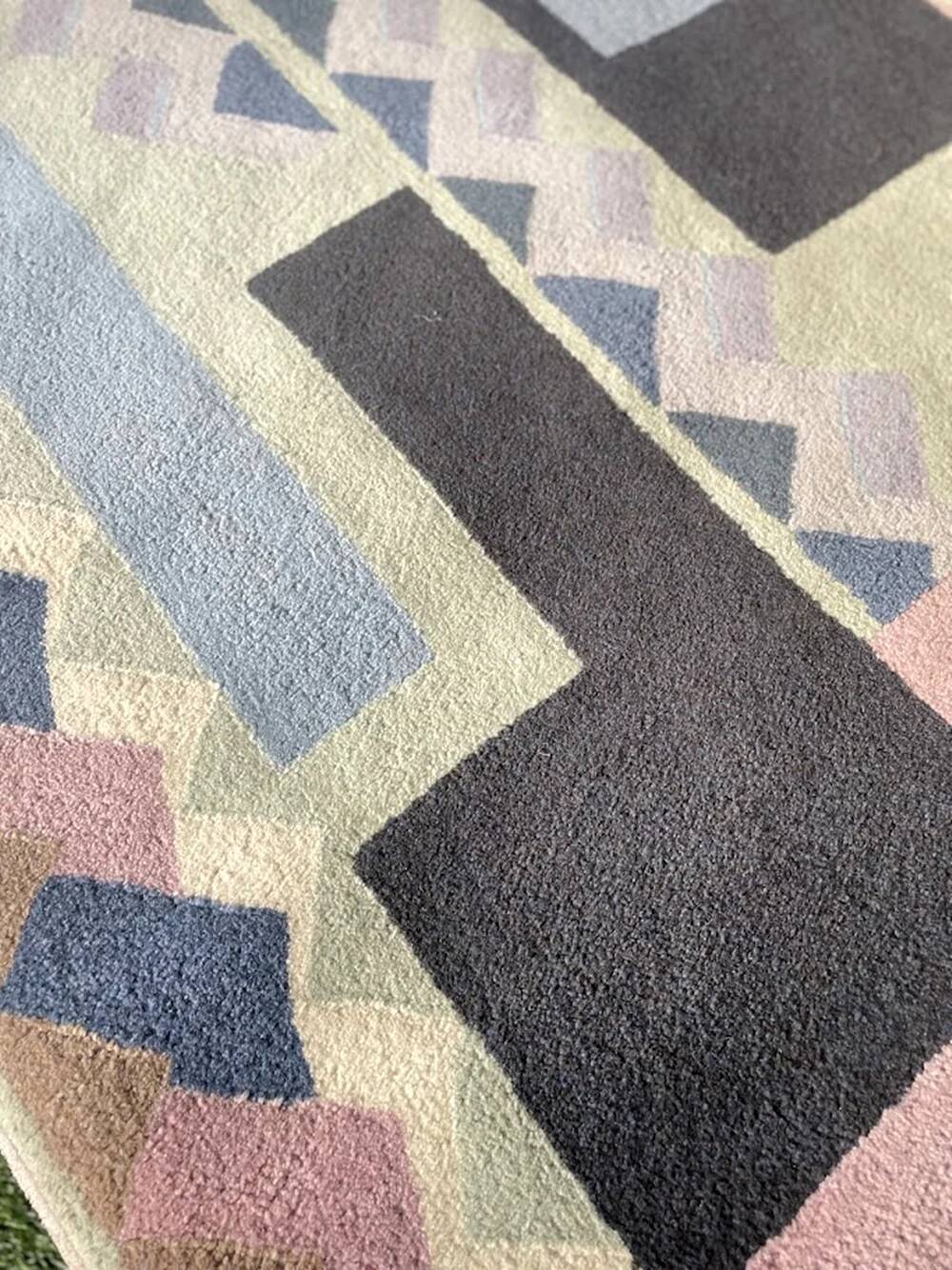 Hand-knotted wool rug by Tisca with a geometric pattern, signed "ILES", France, 1990s.