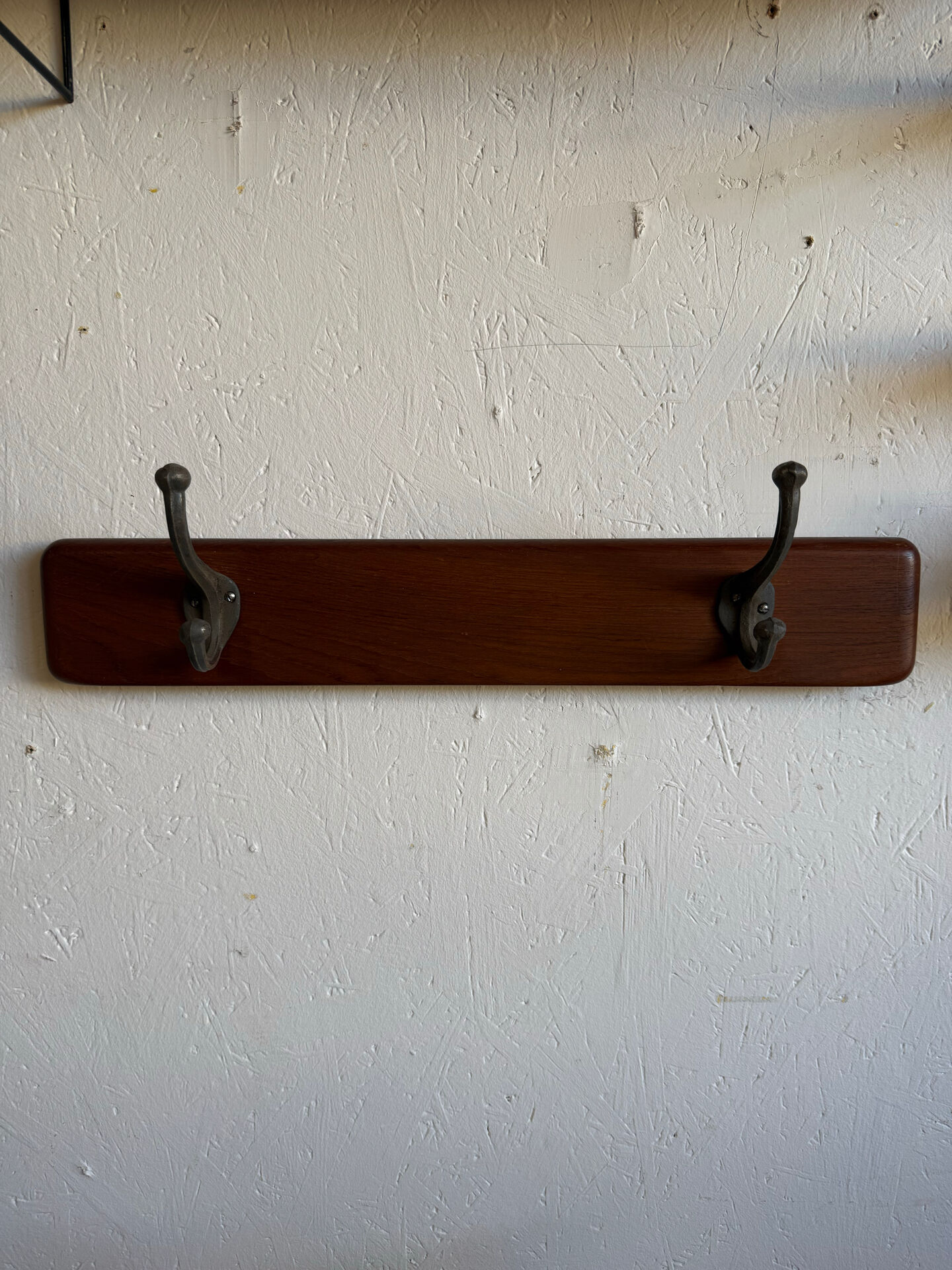 Scandinavian coat rack in solid teak from the 1970s.