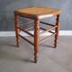 Antique wooden stool with cane seat.