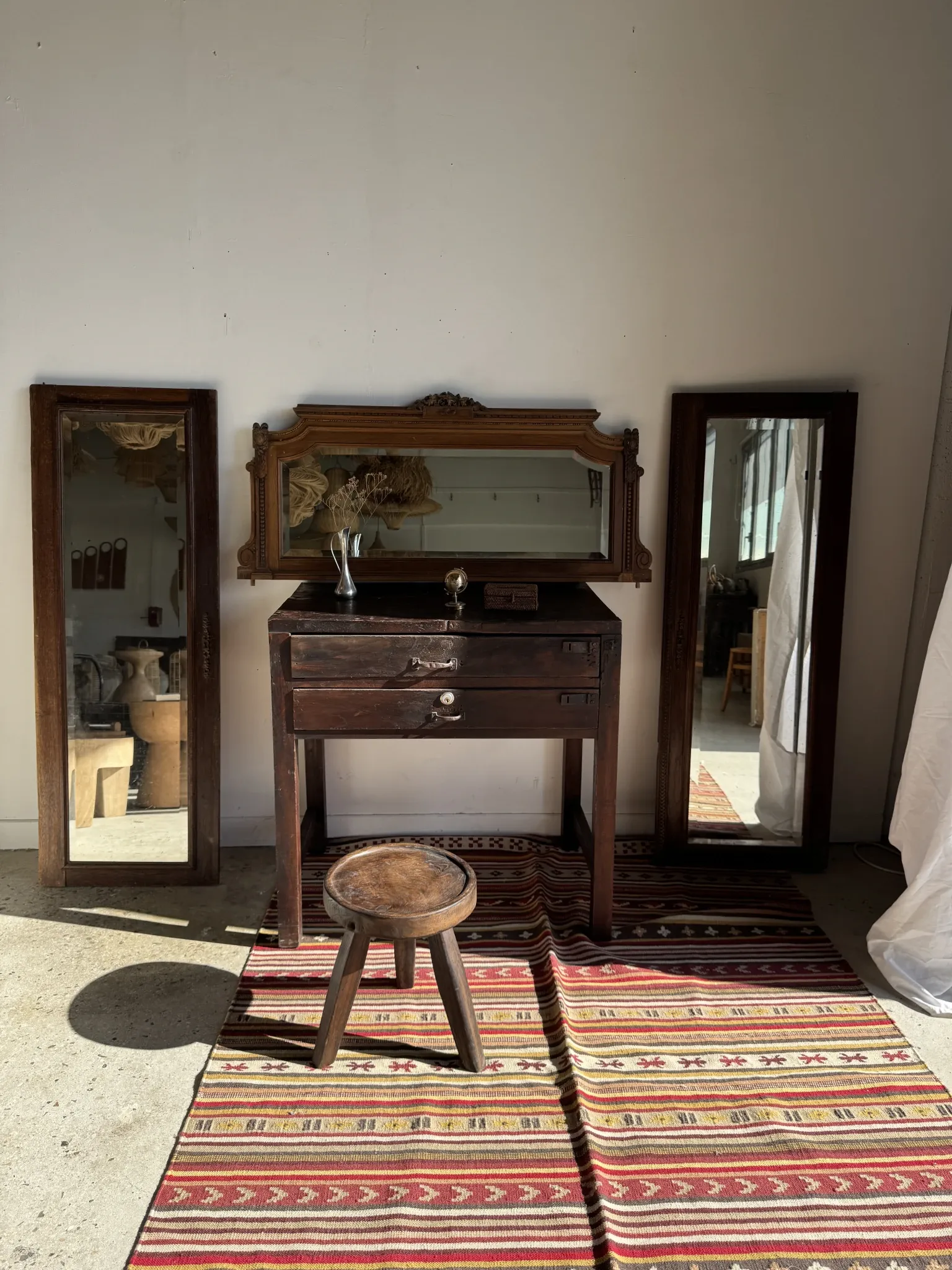 Antique mirror door (left) of a brown oak wardrobe with bevelled glass.