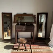 Antique mirror door (left) of a brown oak wardrobe with bevelled glass.