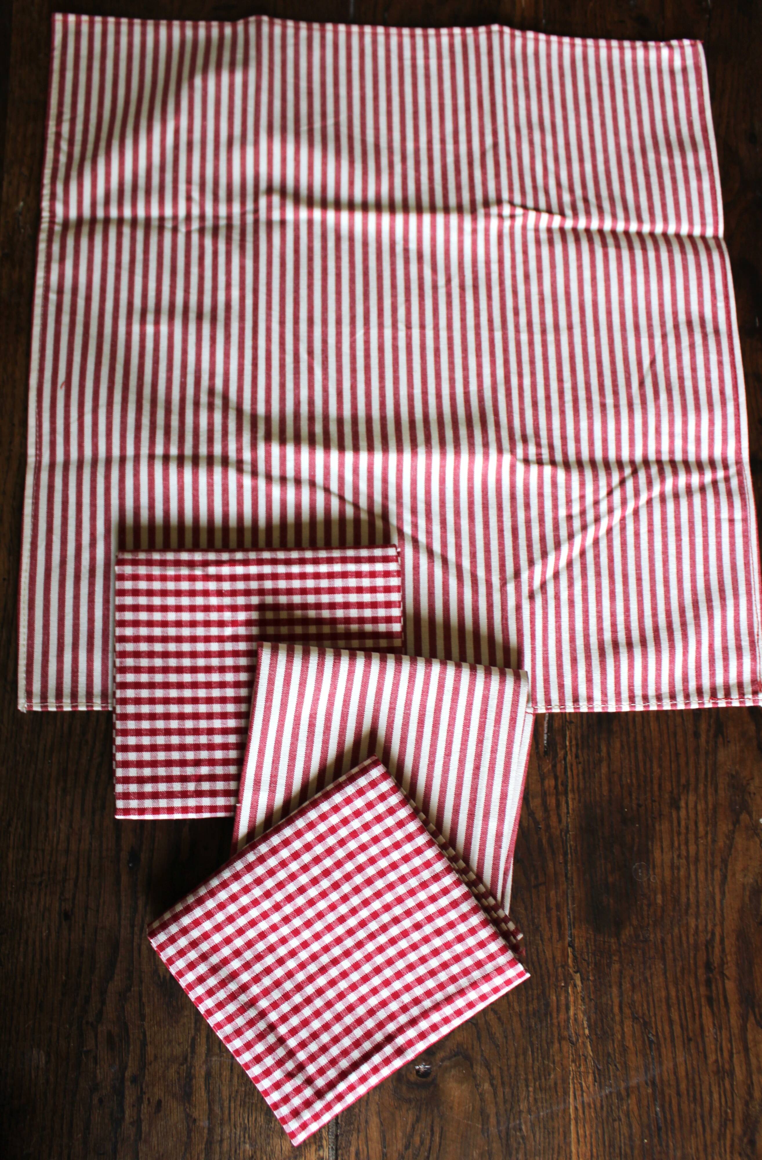 A set of 4 red striped and checkered napkins.