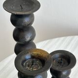 three designer candle holders in matte black metal