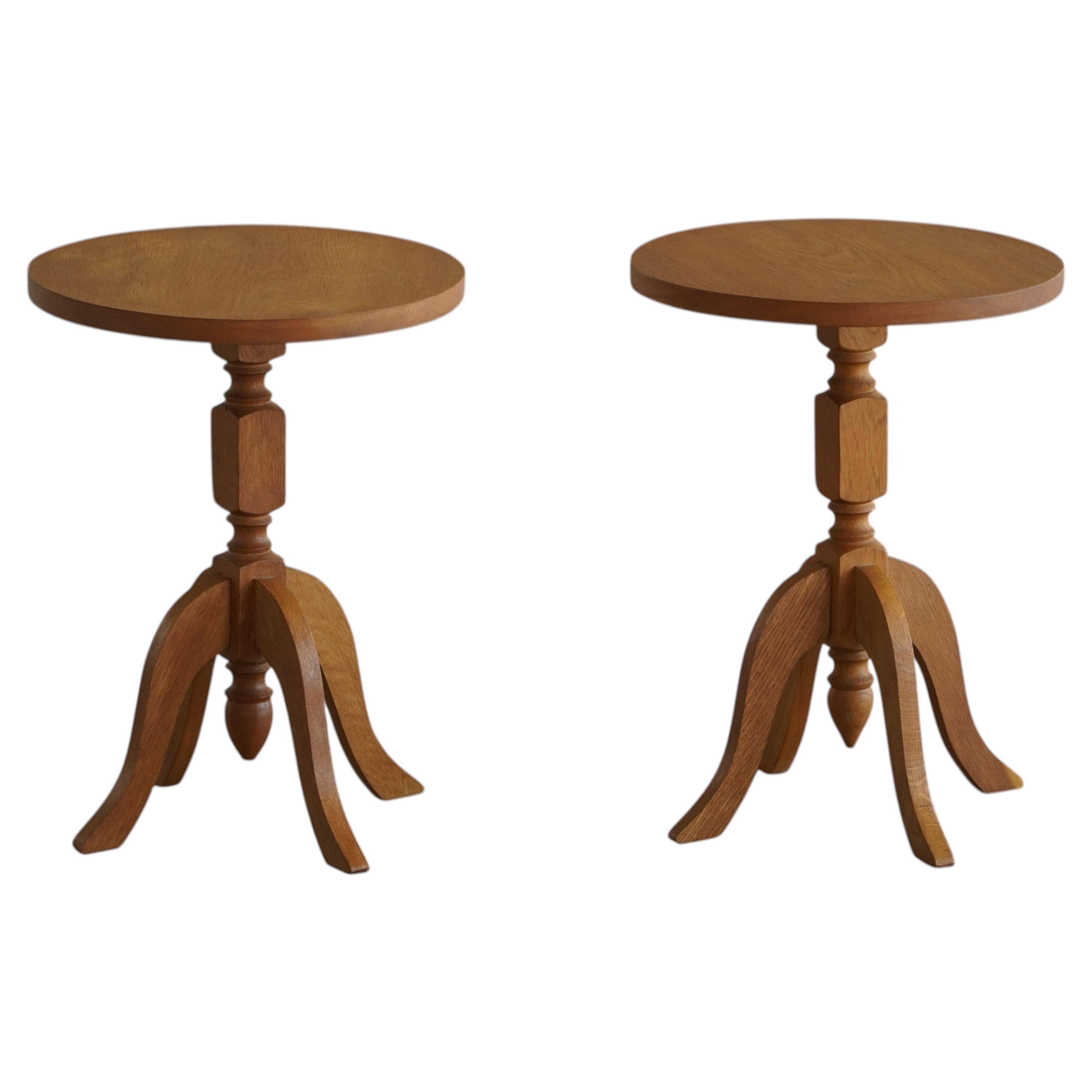 Pair of Scandinavian oak side tables with central legs and sculptural curved feet, 1960s.