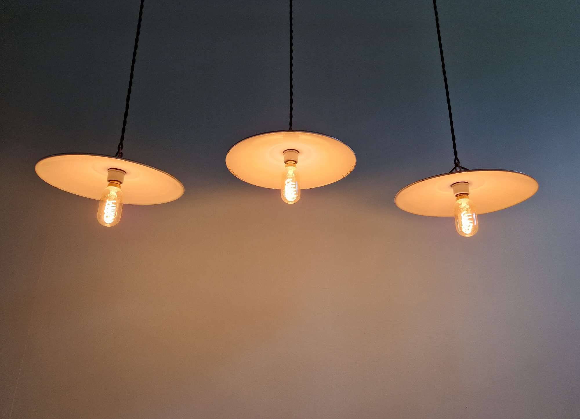 Trio of large industrial suspensions in green enamelled sheet metal.