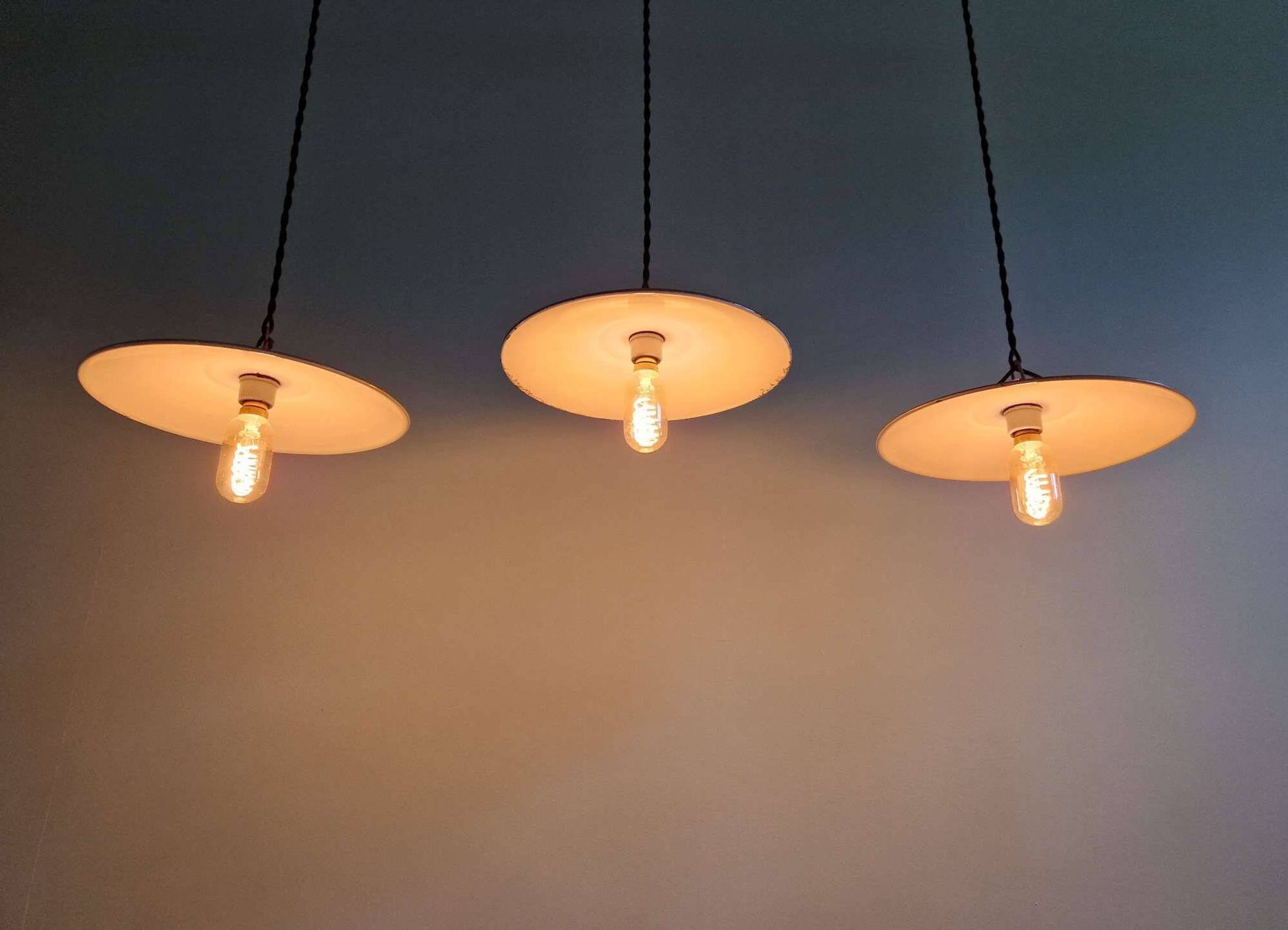Trio of large industrial suspensions in green enamelled sheet metal.