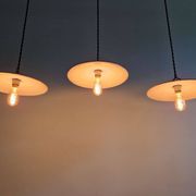 Trio of large industrial suspensions in green enamelled sheet metal.
