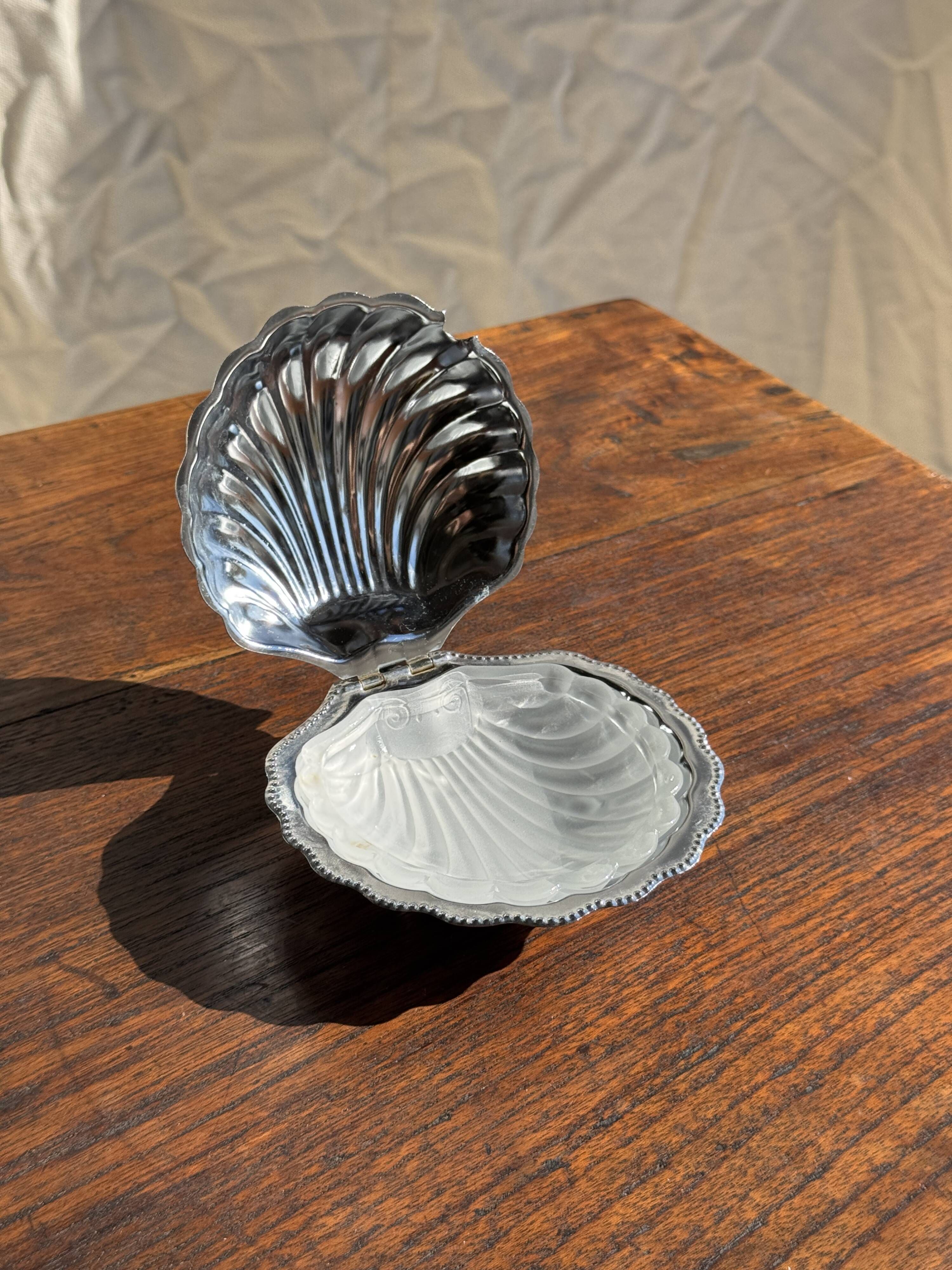 Vintage silver-plated shell butter dish with transparent bowl.