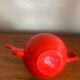 Red enamelled sheet metal teapot