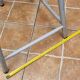 Set of four stackable industrial tubular metal and wood stools