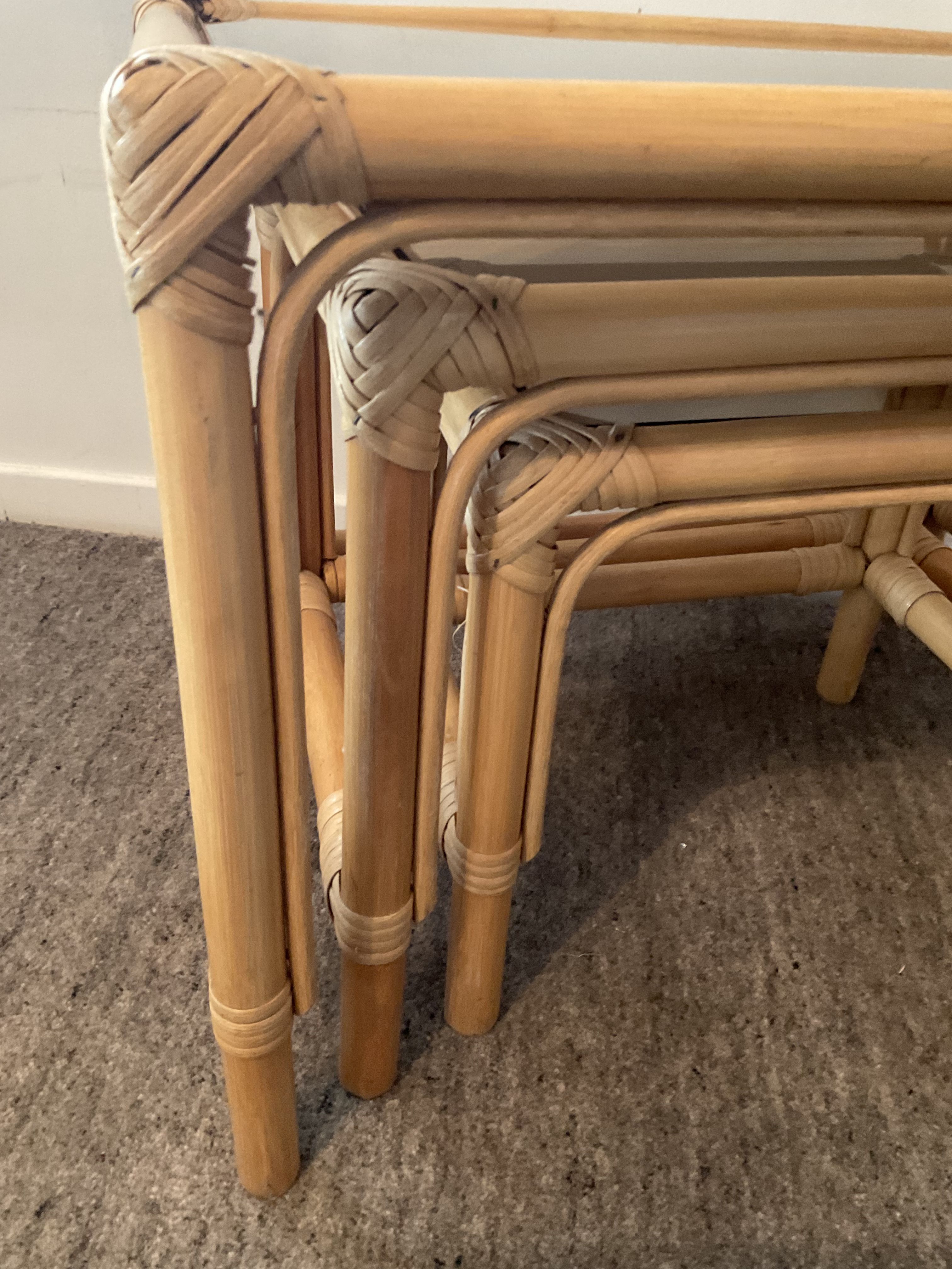 Trio of vintage pull-out tables in rattan and smoked glass 70s