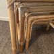 Trio of vintage pull-out tables in rattan and smoked glass 70s