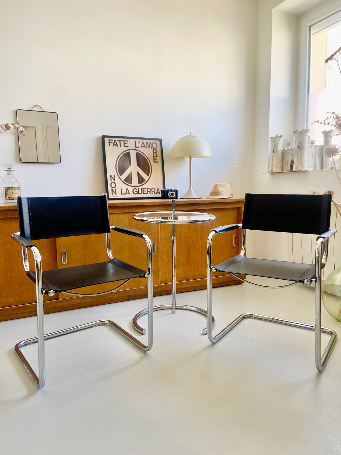 Pair of vintage chrome and black faux leather armchairs