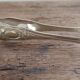 Silver-plated metal lion's paw sugar tongs